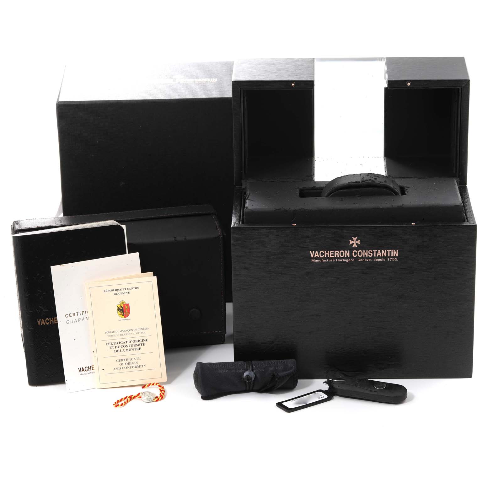 The image shows the packaging, manuals, warranty cards, and accessories for the Traditionnelle model by Vacheron Constantin.