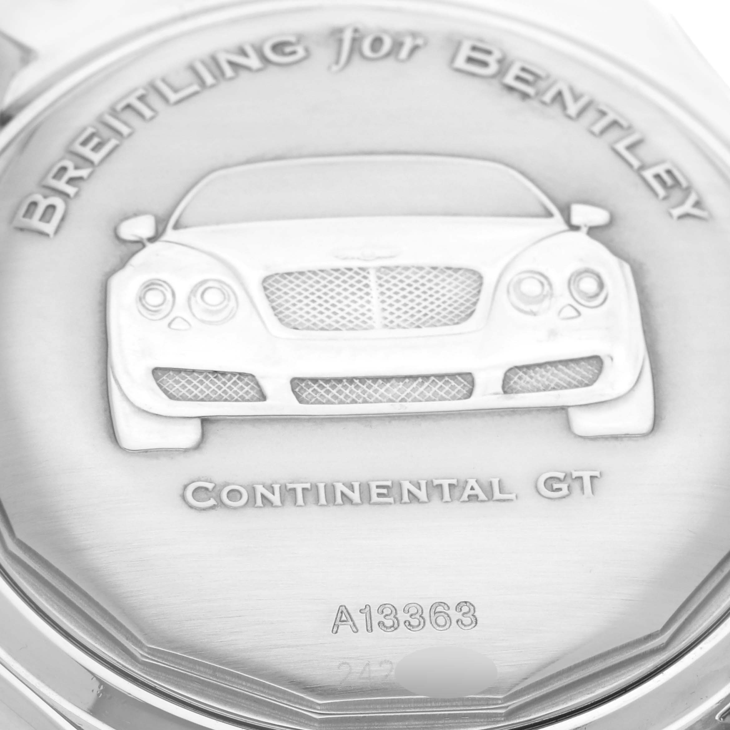The image shows the back of a Breitling for Bentley watch with an engraved Bentley car design.