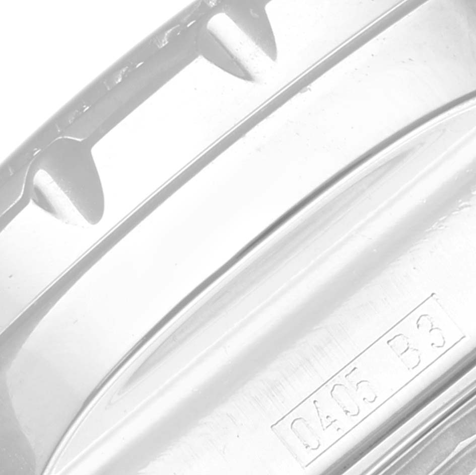 This image shows a close-up of the side edge with indentations and part of an engraved code of a Bentley model by Breitling.