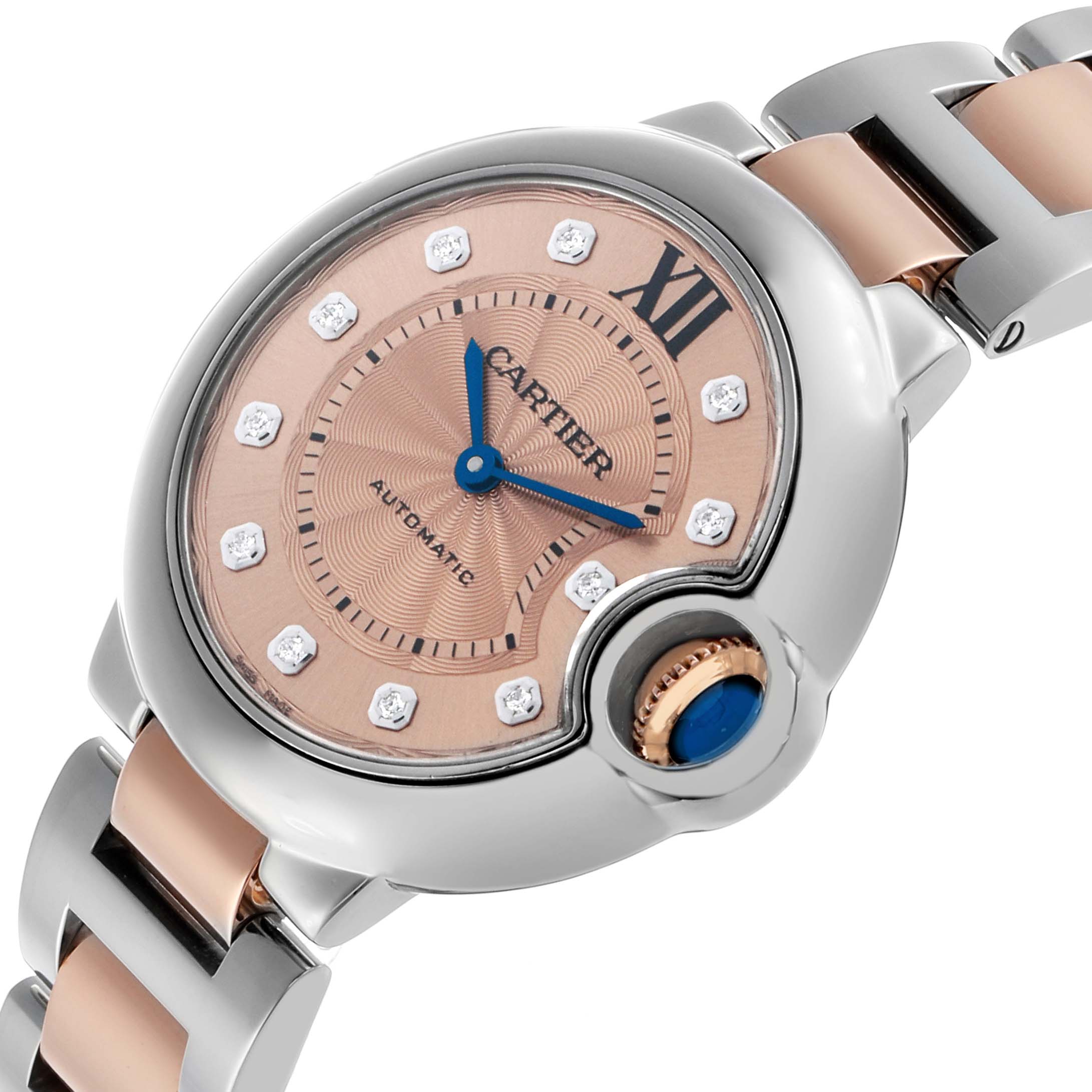 The Cartier Ballon Bleu WE902053 Women's Stainless Steel Pink Dial watch is shown at an angled close-up, detailing the face, crown, and part of the bracelet.