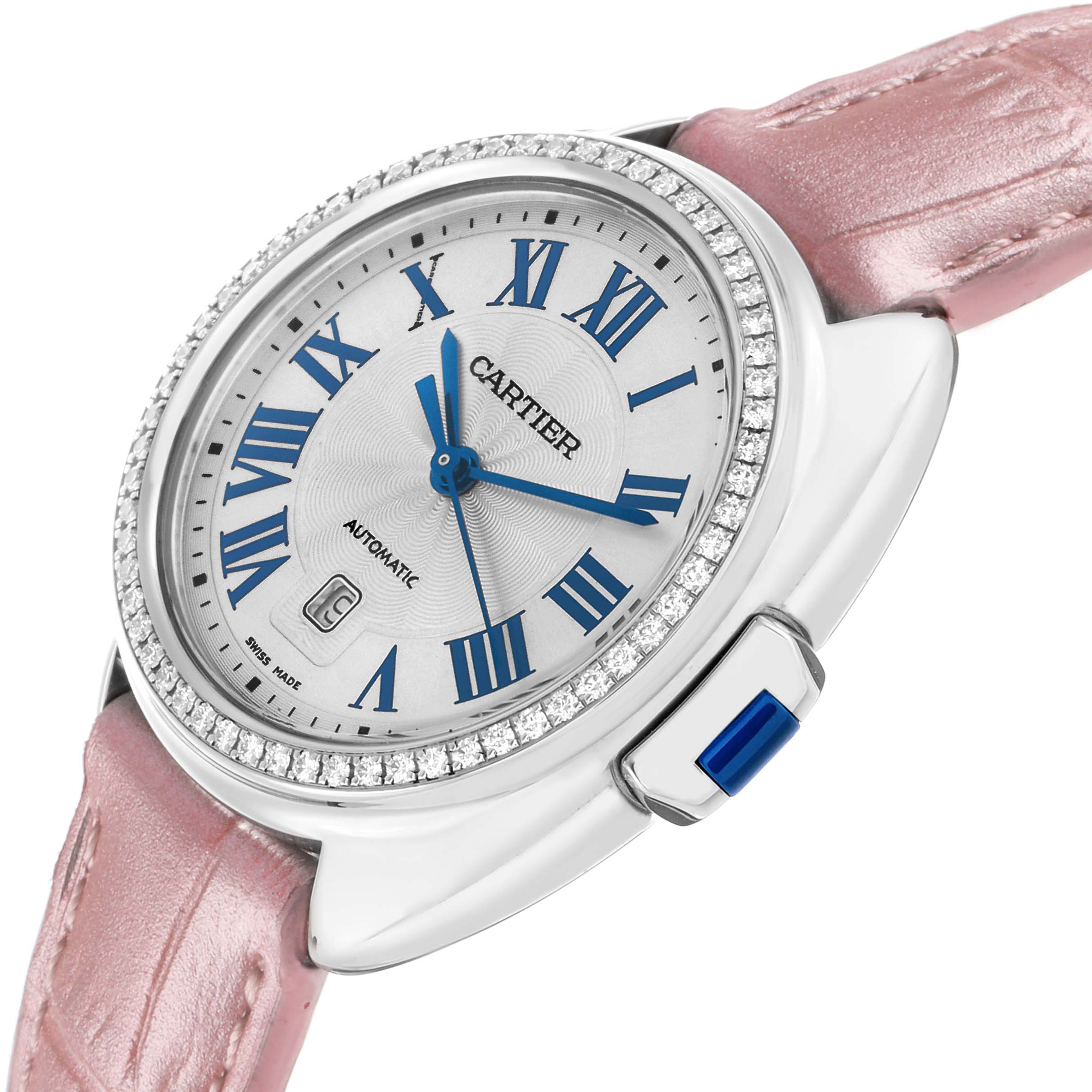The Cartier Clé watch is shown at an angle highlighting its face, diamond bezel, crown, and pink strap.