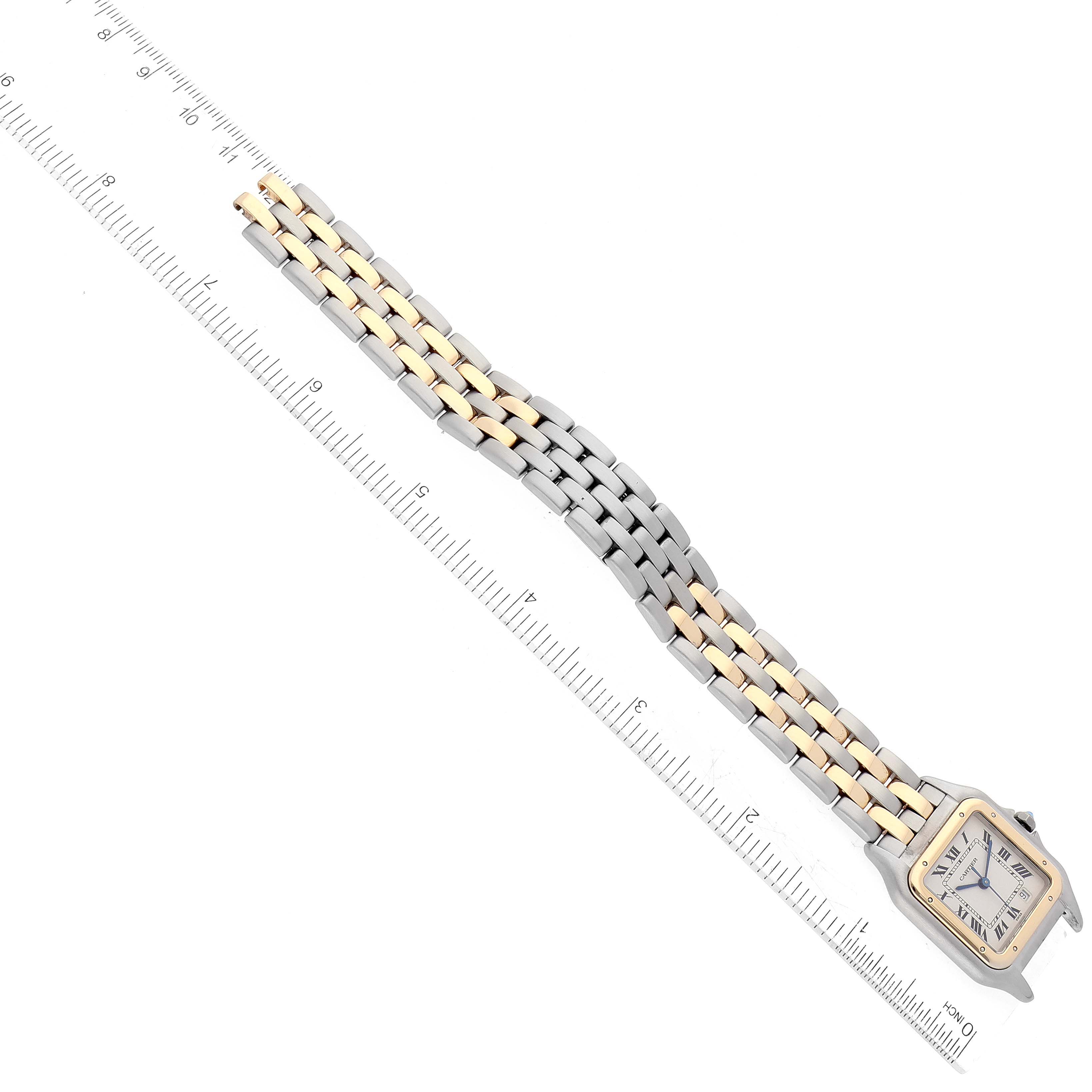 The Cartier Panthere W25028B6 Women's Steel and Gold (two tone) Silver Dial W25028B6 Women's Steel and Gold (two tone) Silver Dial watch is shown from a top view, displaying the face and full length of its two-tone bracelet beside a ruler.
