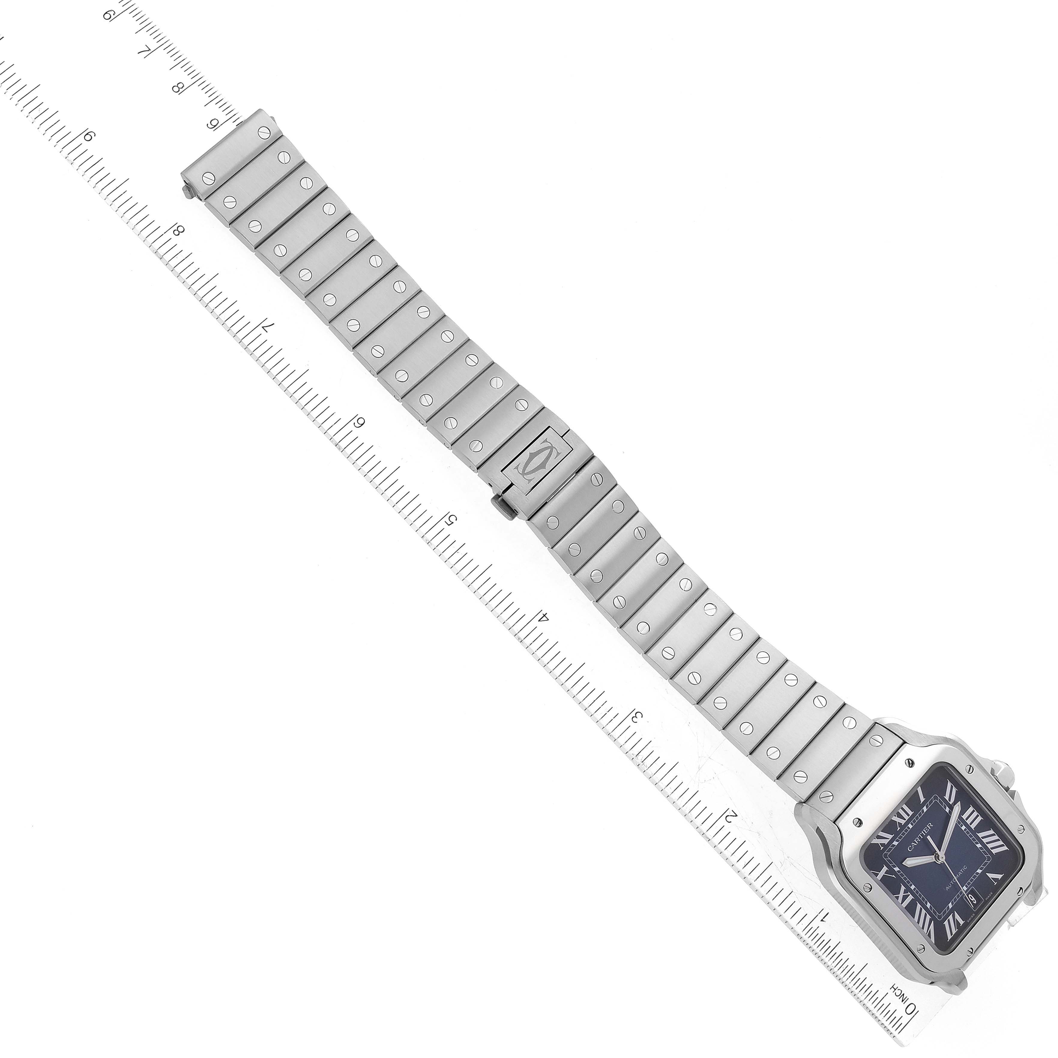The image shows an overhead view of a Santos model by Cartier, showcasing the watch face, bracelet, and clasp.