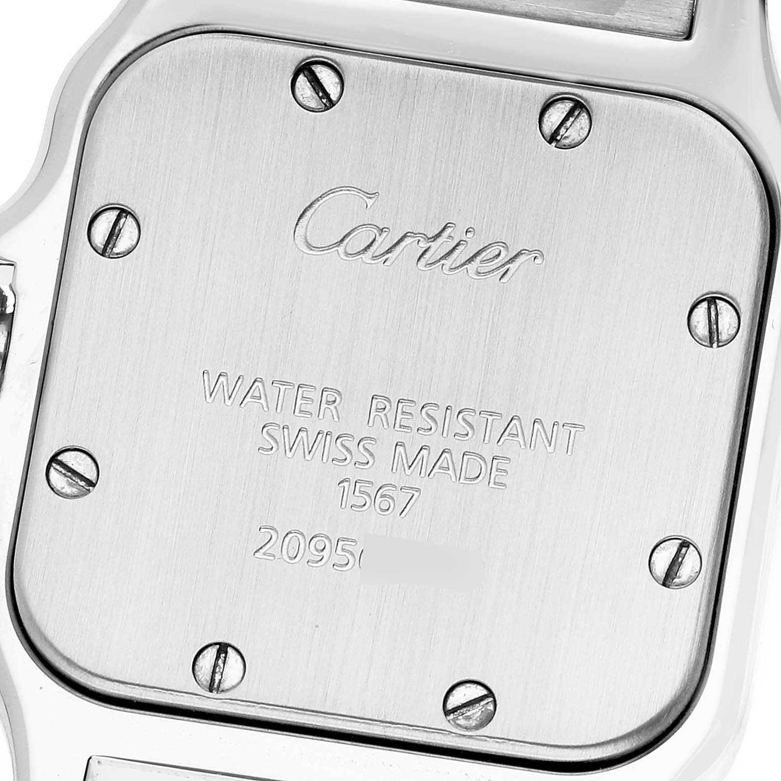 This is a close-up of the back case of the Santos model watch by Cartier, showing screws and engravings.