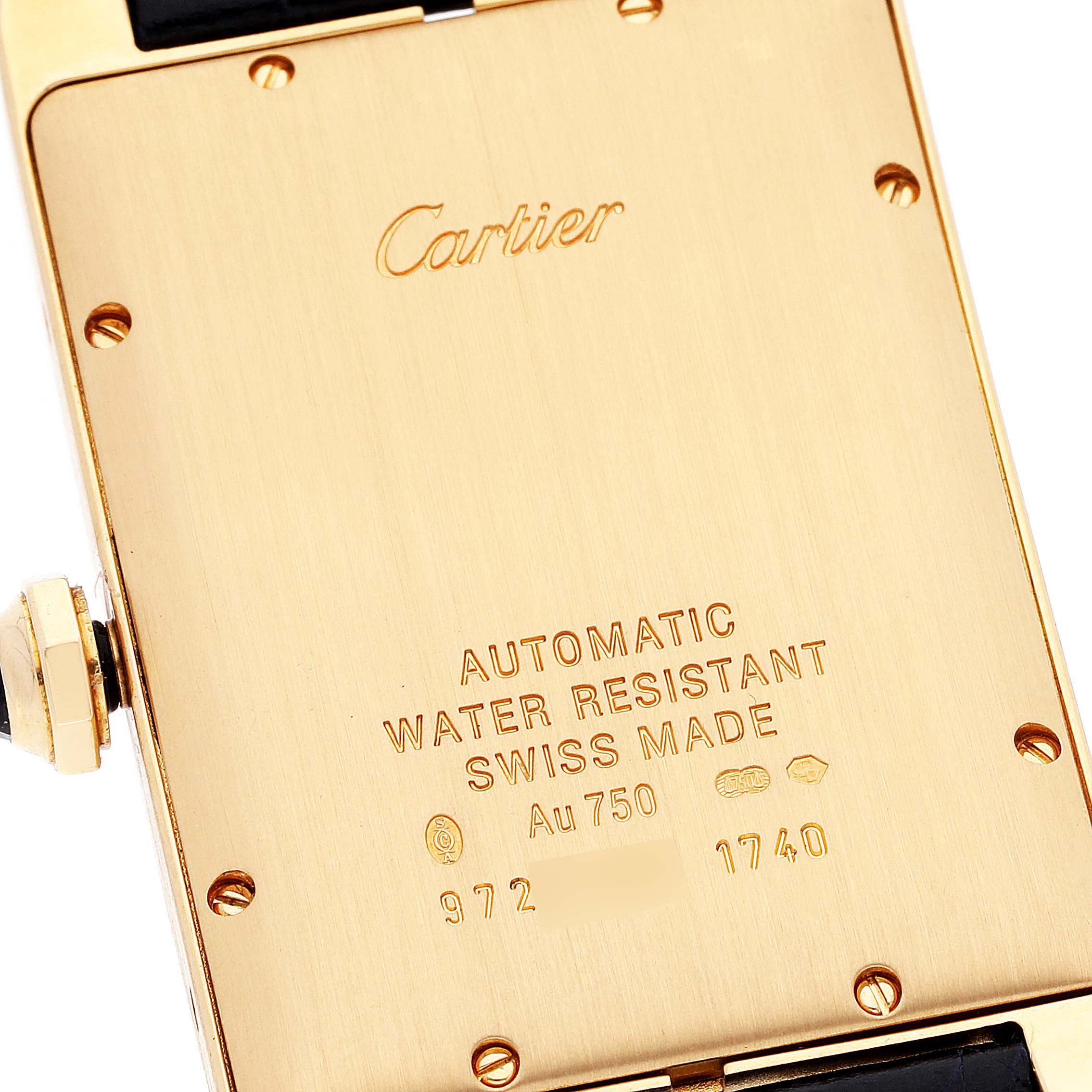The image shows the case back of a Cartier Tank Americaine W2603156 Men's Yellow Gold Silver Dial W2603156 Men's Yellow Gold Silver Dial watch, highlighting its inscriptions and screws.
