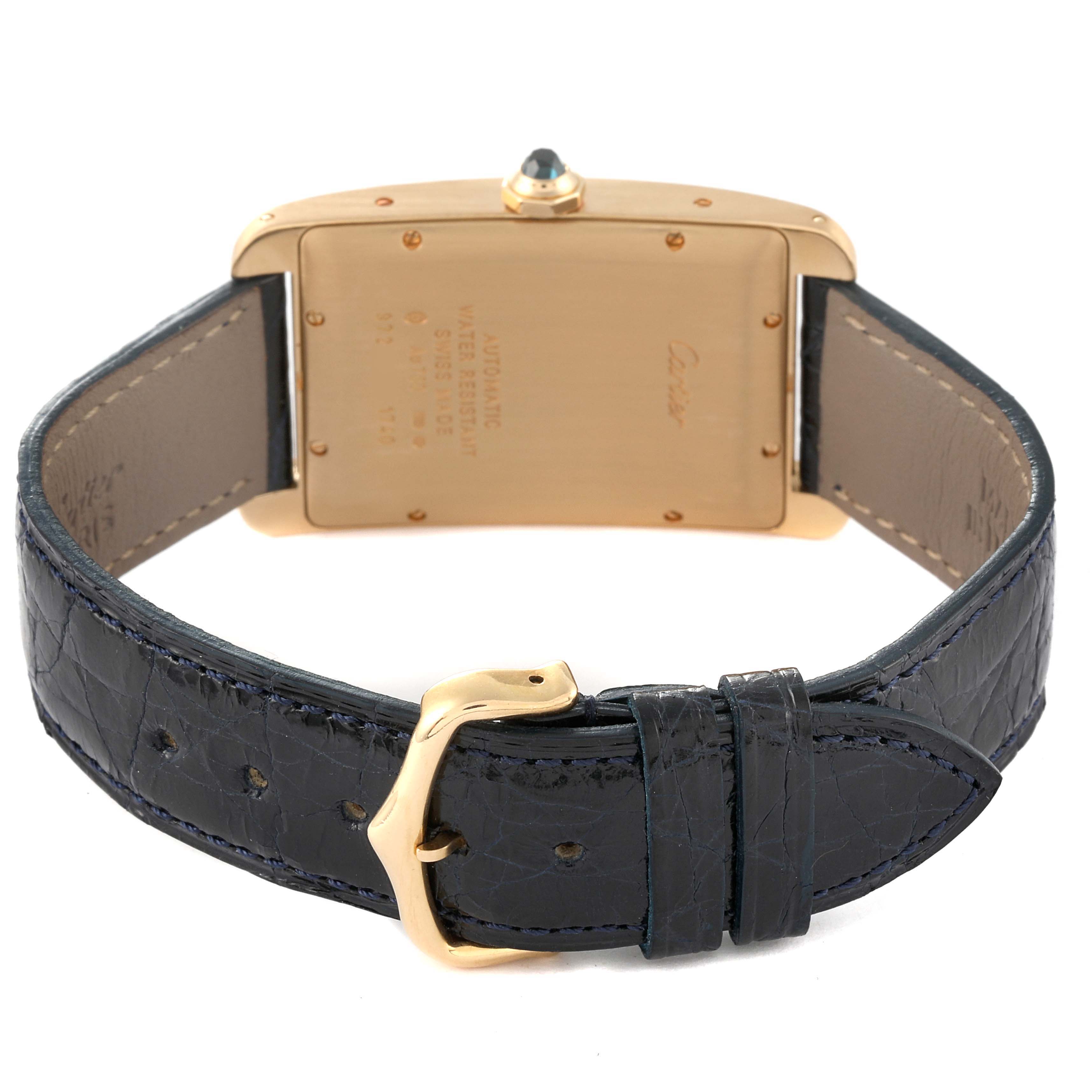 The image shows the back of a Cartier Tank Americaine W2603156 Men's Yellow Gold Silver Dial W2603156 Men's Yellow Gold Silver Dial watch with a leather strap and deployment clasp.