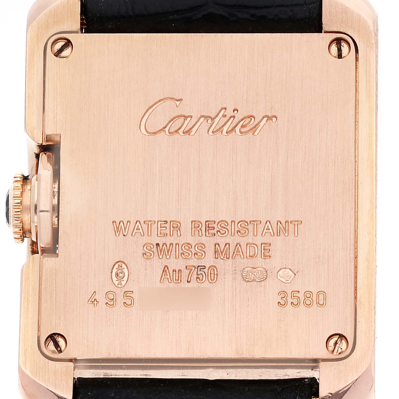 This image shows the back case of a Tank Anglaise watch by Cartier, displaying inscriptions and a portion of the leather strap.