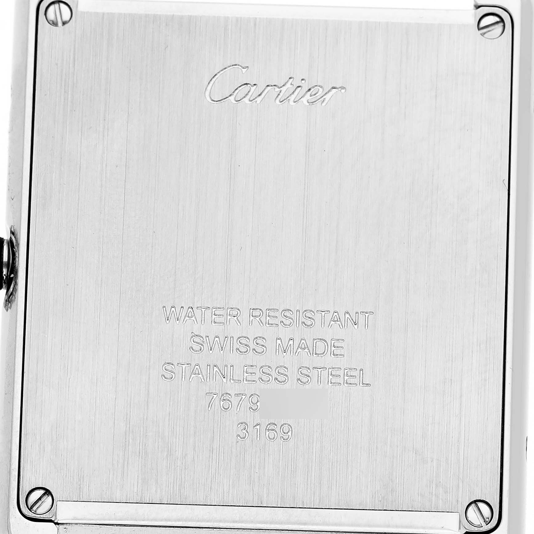 The image shows the back plate of a Cartier Tank Solo WSTA0028 Men's Stainless Steel Silver Dial watch emphasizing its engraving and material details.