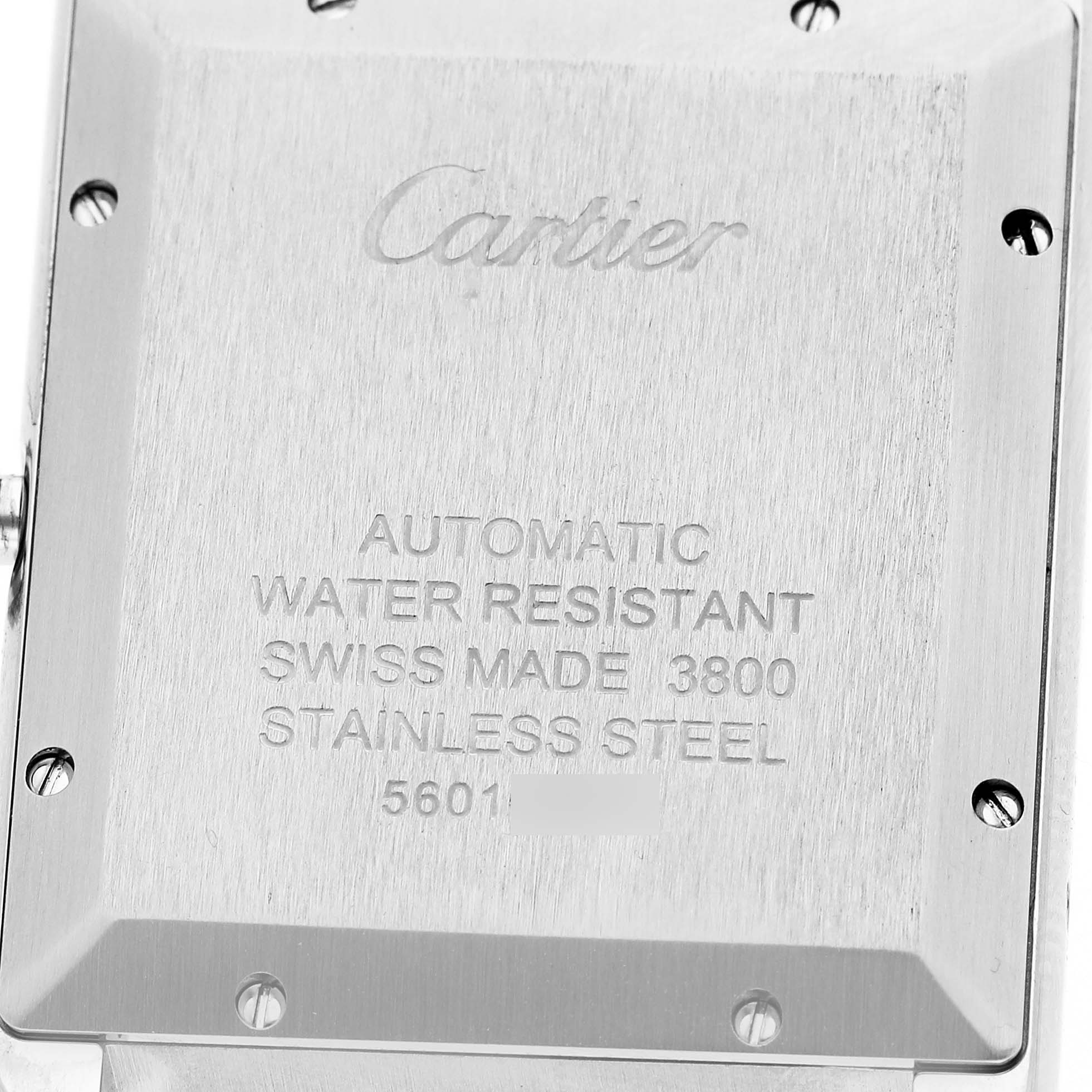 The image shows the backside of a Cartier Tank Solo W5200027 Men's Stainless Steel Silver Dial watch with engraved details about its features.