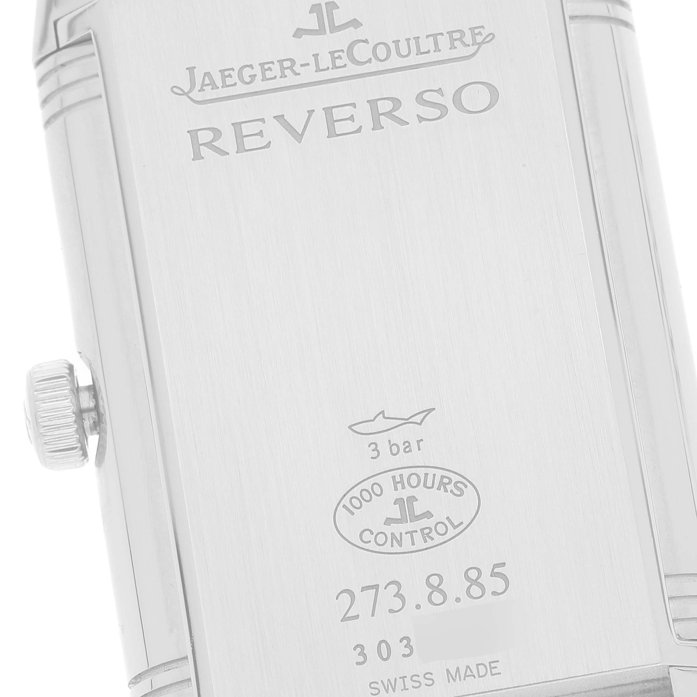 The image shows the back case of a Jaeger-LeCoultre Reverso watch with its crown and engravings.