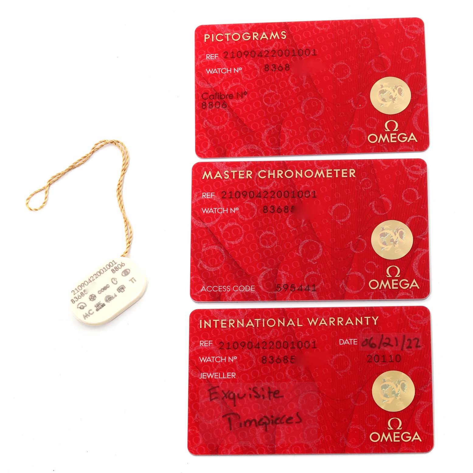 This image shows three red cards (Pictograms, Master Chronometer, International Warranty) and a tag from an Omega Seamaster 210.90.42.20.01.001 Men's Titanium Brown Dial 210.90.42.20.01.001 Men's Titanium Brown Dial watch.