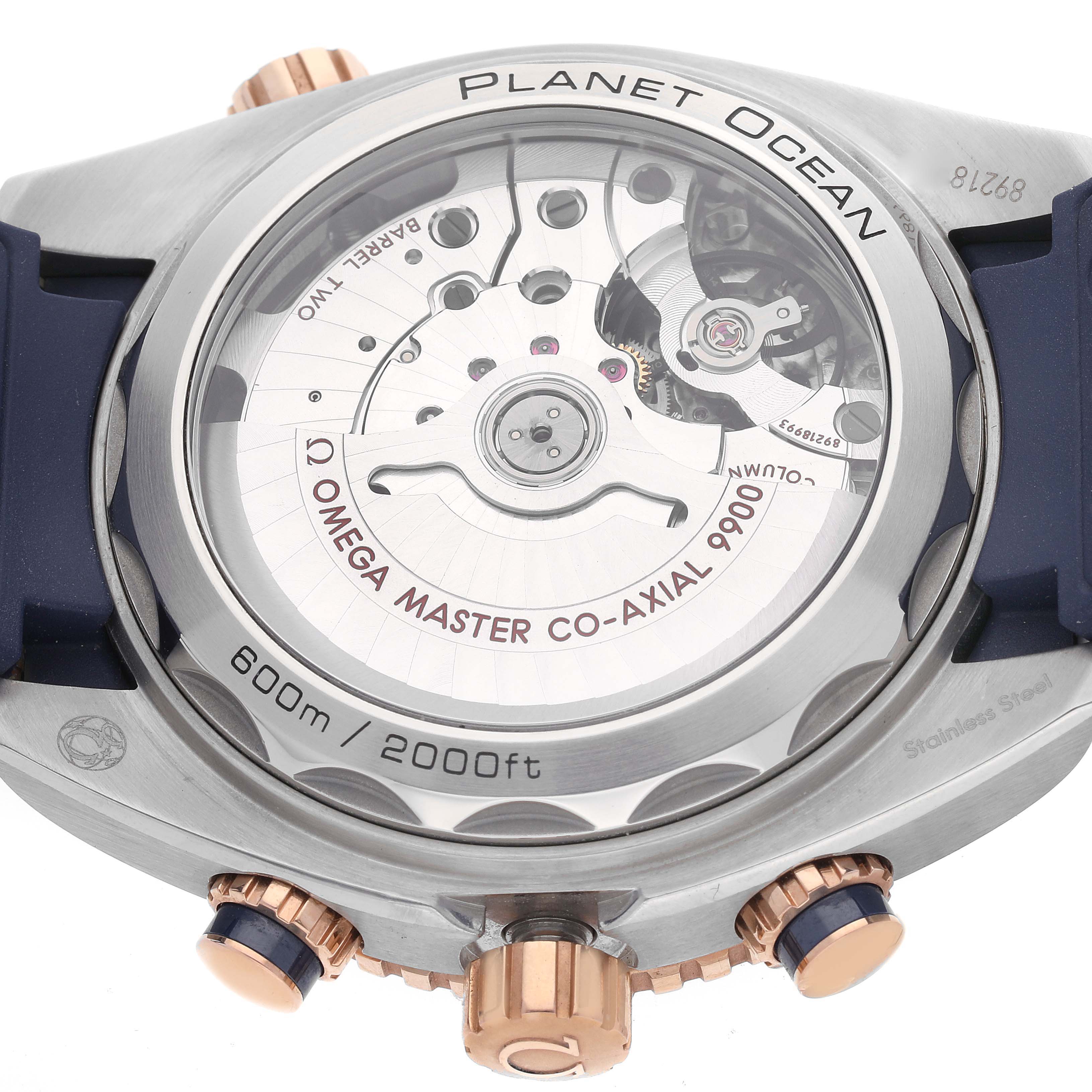 The image shows the back view of an Omega Planet Ocean 215.23.46.51.03.001 Men's Steel and Gold (two tone) Blue Dial 215.23.46.51.03.001 Men's Steel and Gold (two tone) Blue Dial watch, highlighting its transparent case back and inner mechanisms.