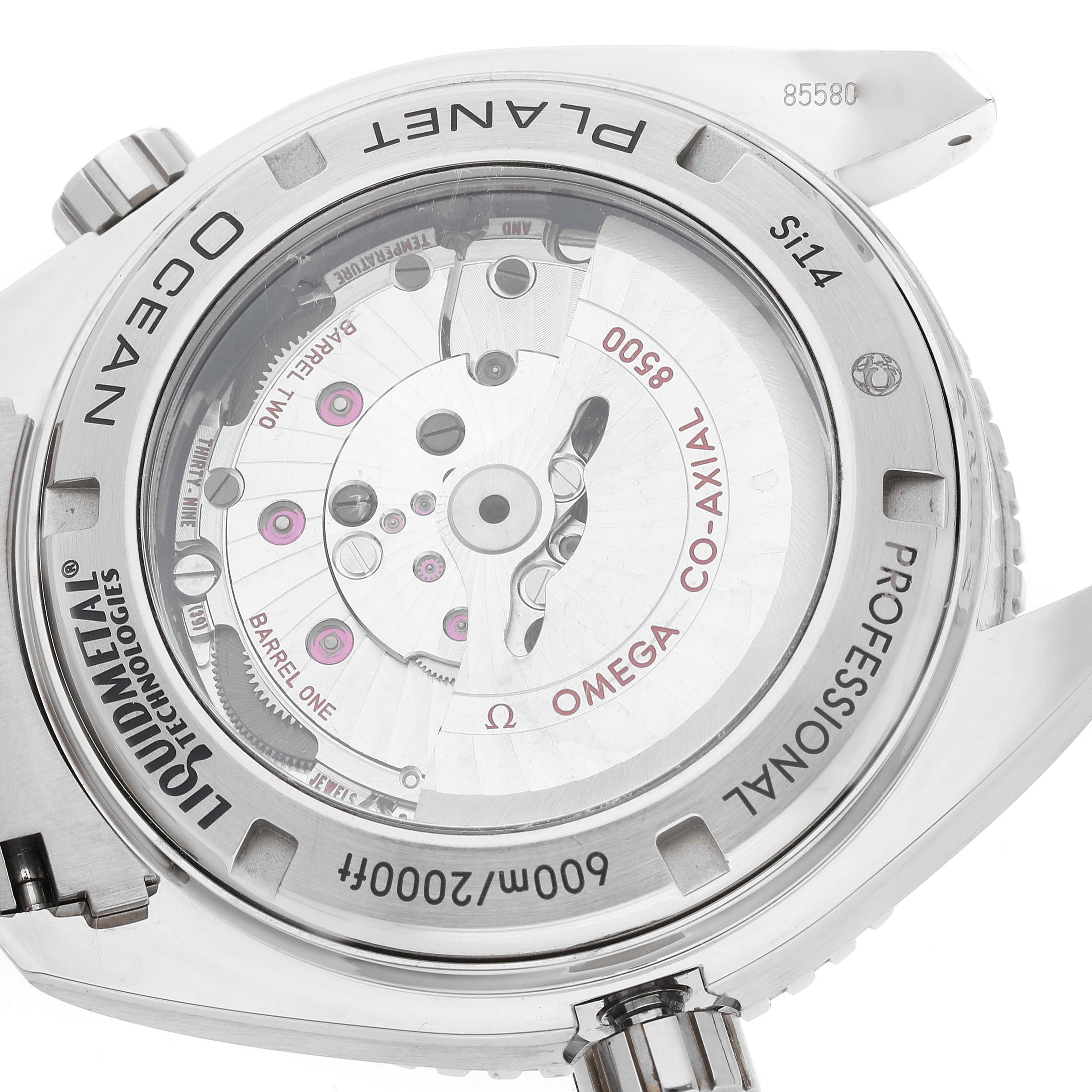 The image shows an angled view of the Omega Planet Ocean 232.90.46.21.03.001 Men
s Titanium Blue Dial 232.90.46.21.03.001 Men
s Titanium Blue Dial watch
s transparent case back, revealing its internal mechanism.