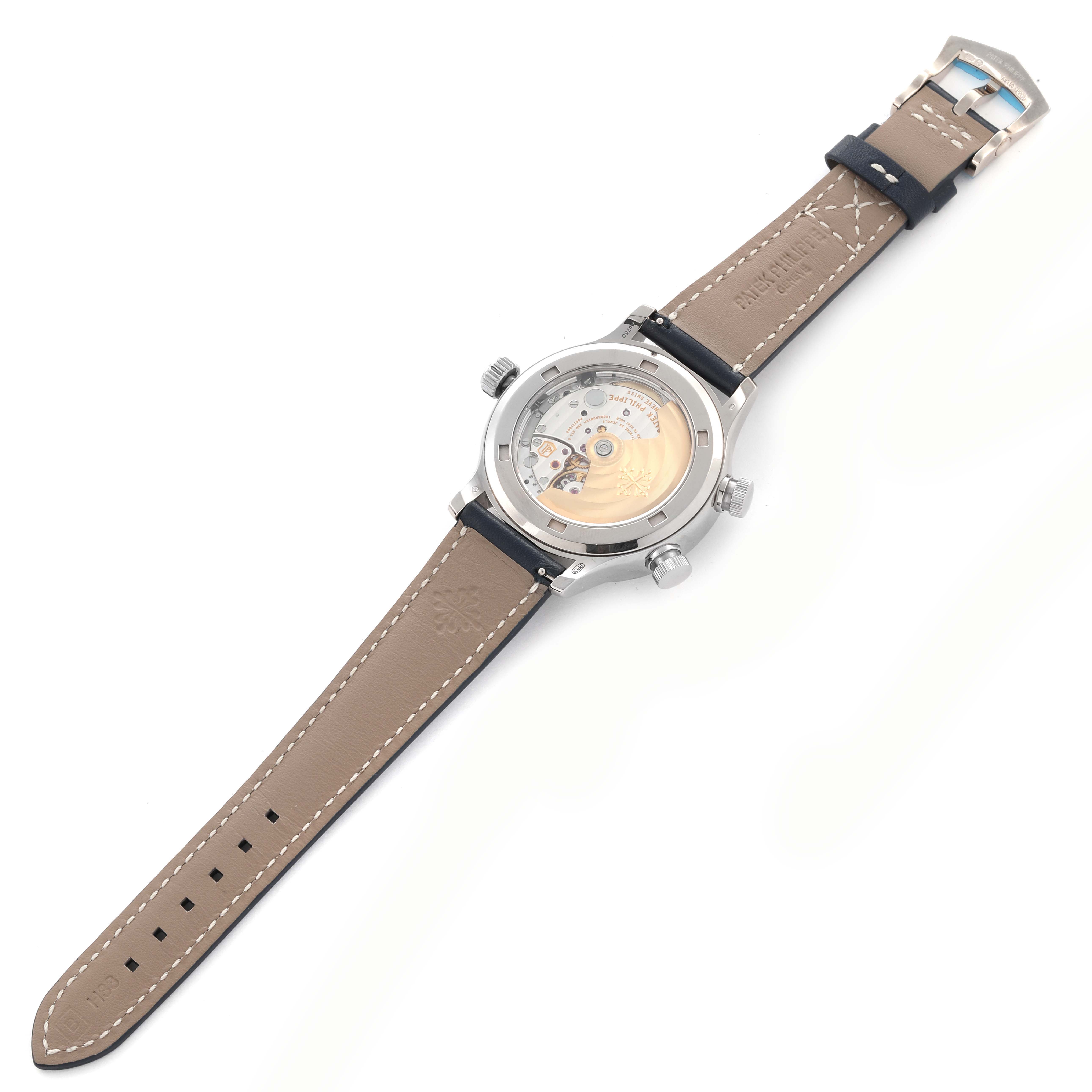 The Patek Philippe Calatrava 7234G-001 Men's White Gold Blue Dial 7234G-001 Men's White Gold Blue Dial watch is shown from the back, displaying its exhibition case back and brown leather strap.