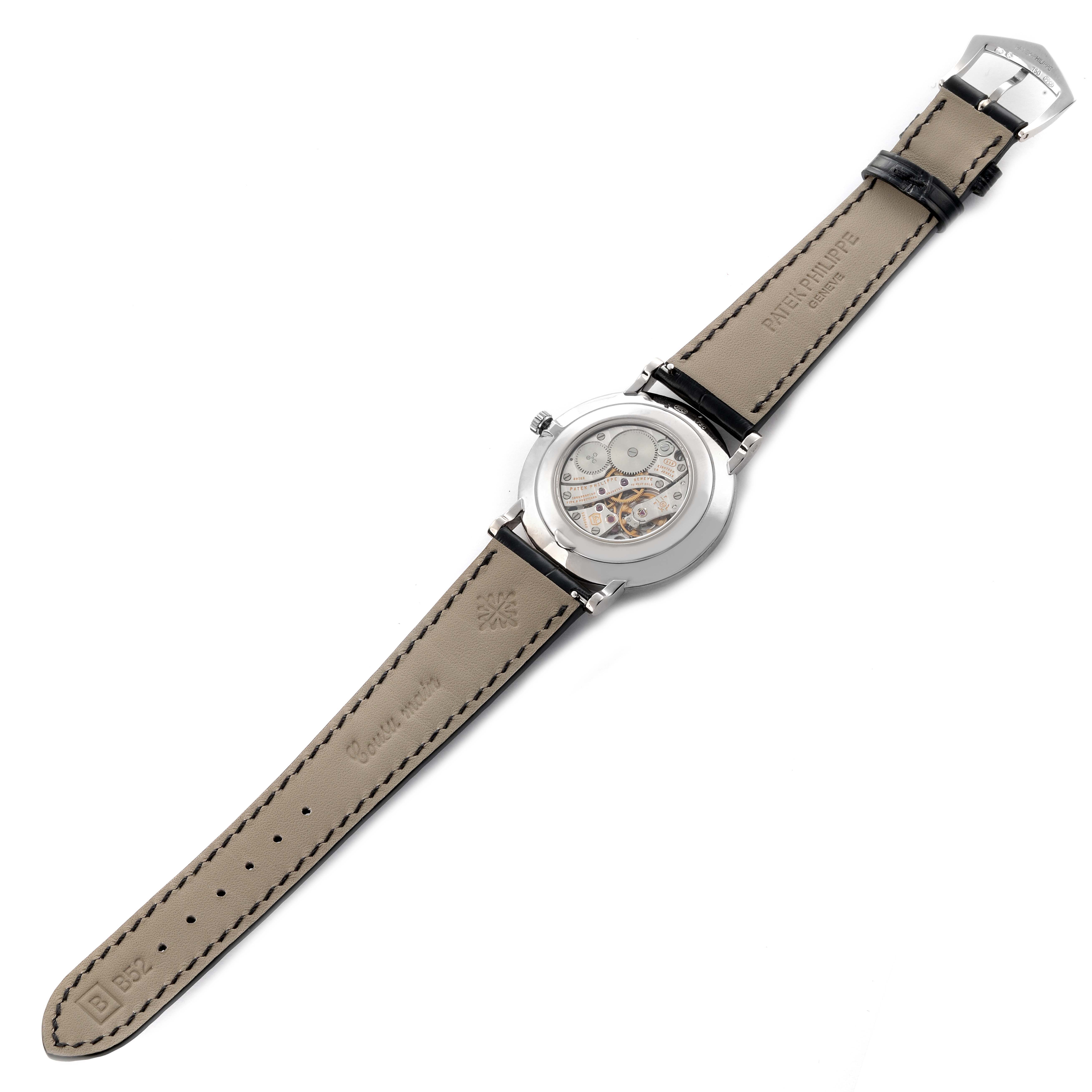 The Patek Philippe Calatrava 5116G-001 Men's White Gold White Dial 5116G-001 Men's White Gold White Dial watch is shown from the back, featuring its movement and leather strap.