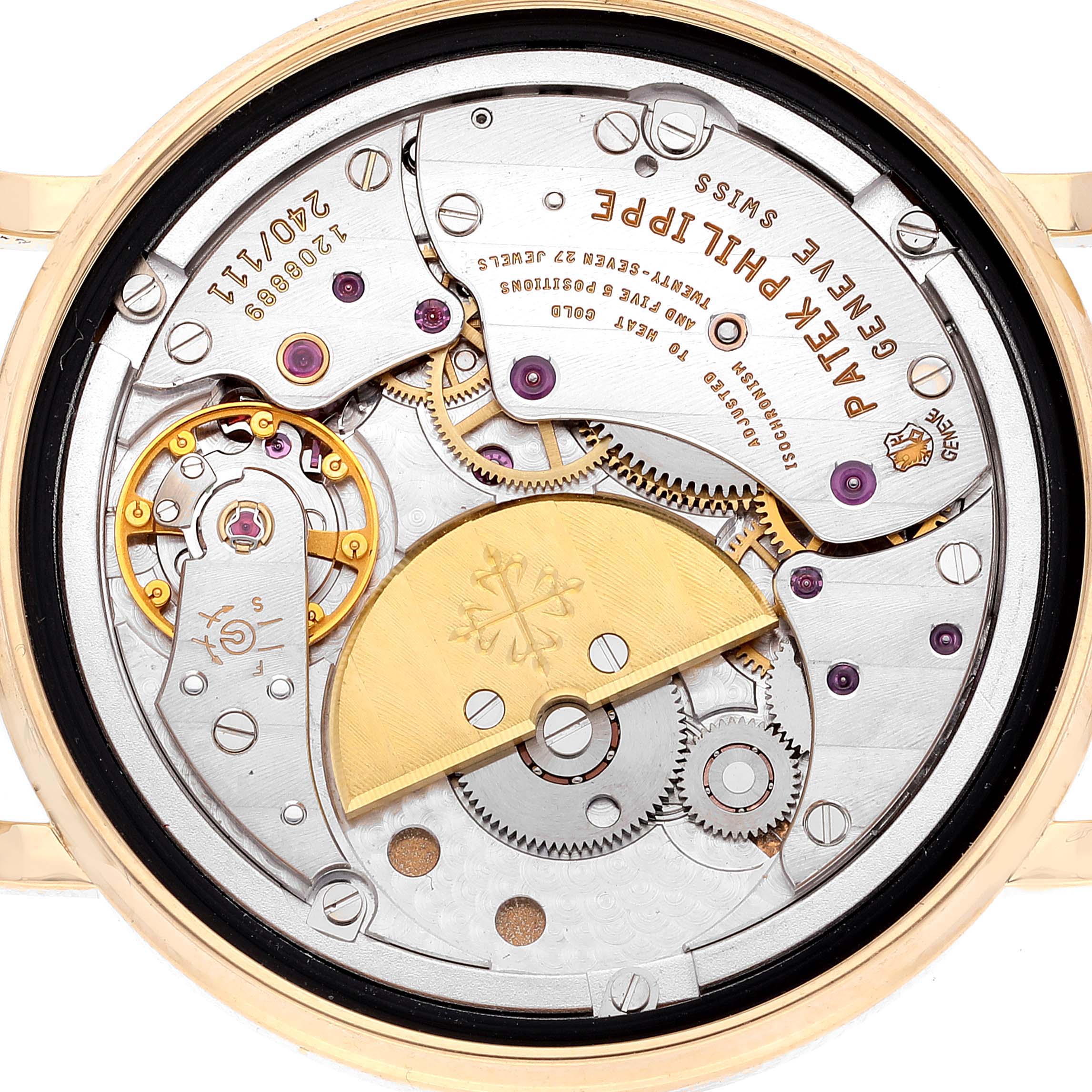 The image shows the back of a Patek Philippe Calatrava 5120J Men's Yellow Gold White Dial 5120J Men's Yellow Gold White Dial watch, revealing its intricate movement and components.