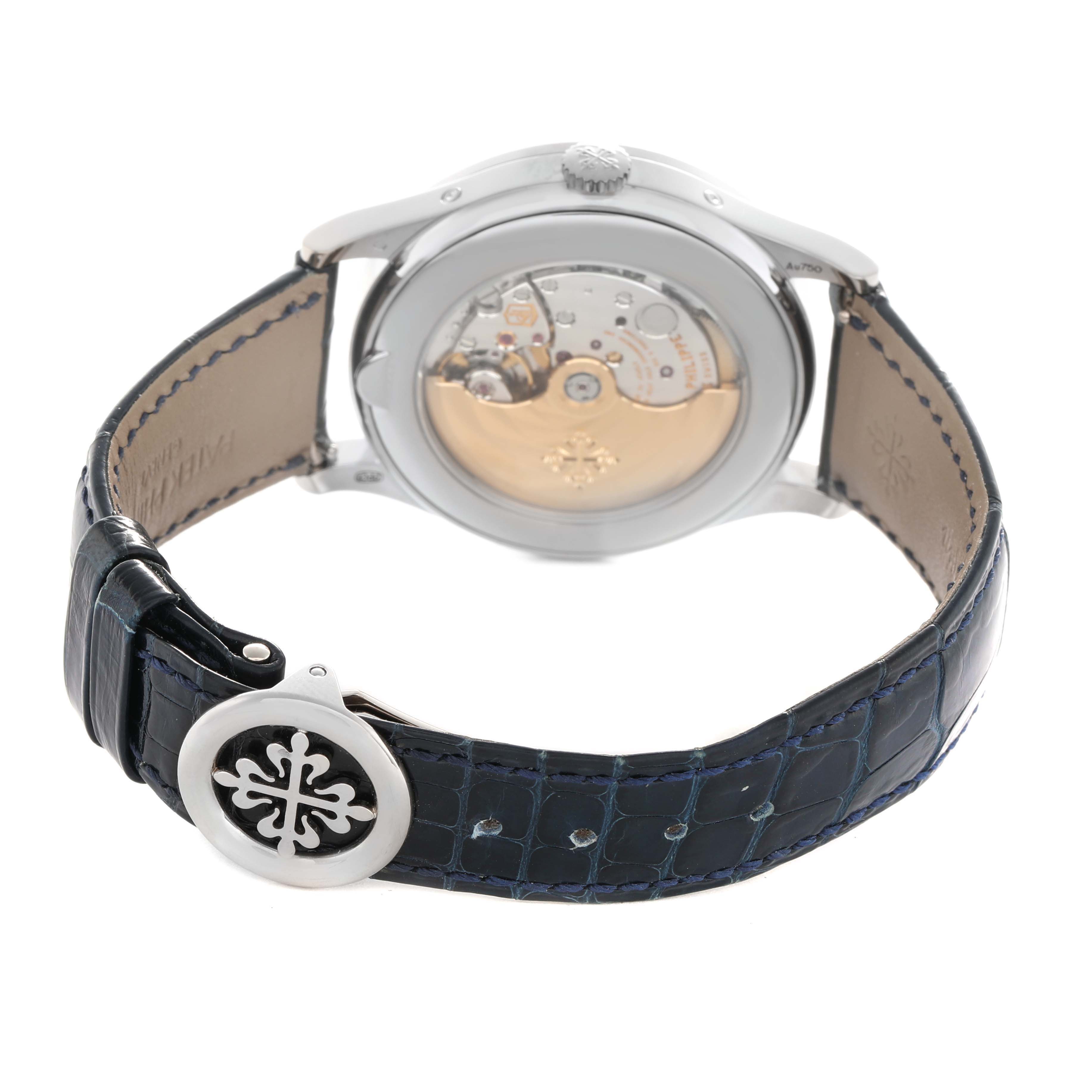 The image shows the back of a Patek Philippe Complications 5396G-017 Men's White Gold Blue Dial watch, highlighting the movement and the strap clasp.