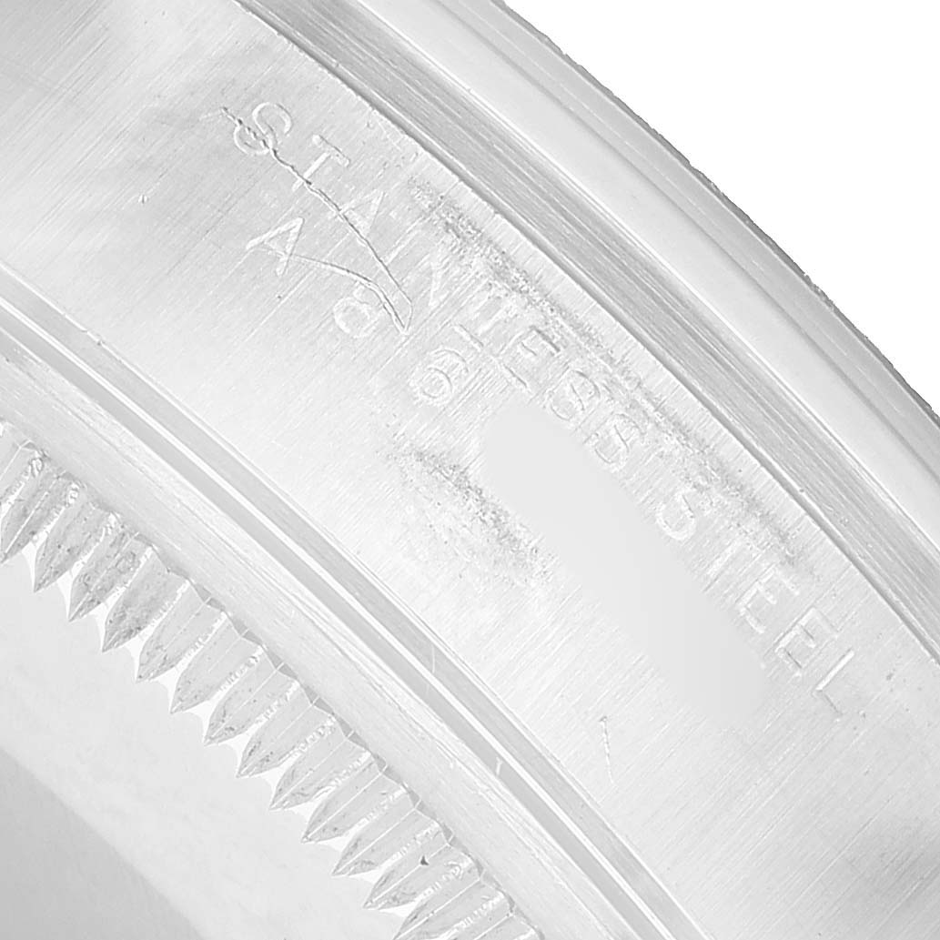 This close-up shows the edge of the case-back and the engraved "STAINLESS STEEL" text on the Rolex Date 15200 Men's Stainless Steel Black Dial model watch.