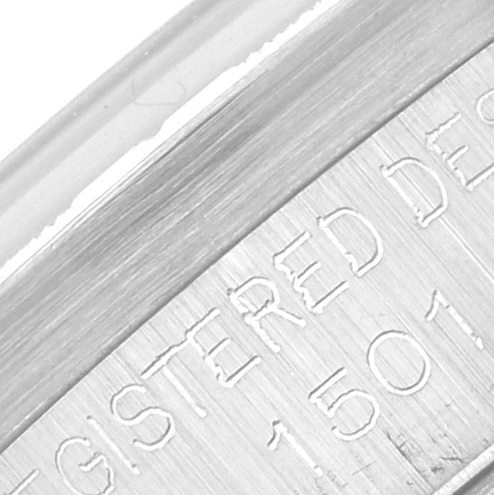 This image shows a close-up of the engraved text on the bezel of a Rolex Vintage Collection 1501 Men's Stainless Steel Silver Dial 1501 Men's Stainless Steel Silver Dial model.