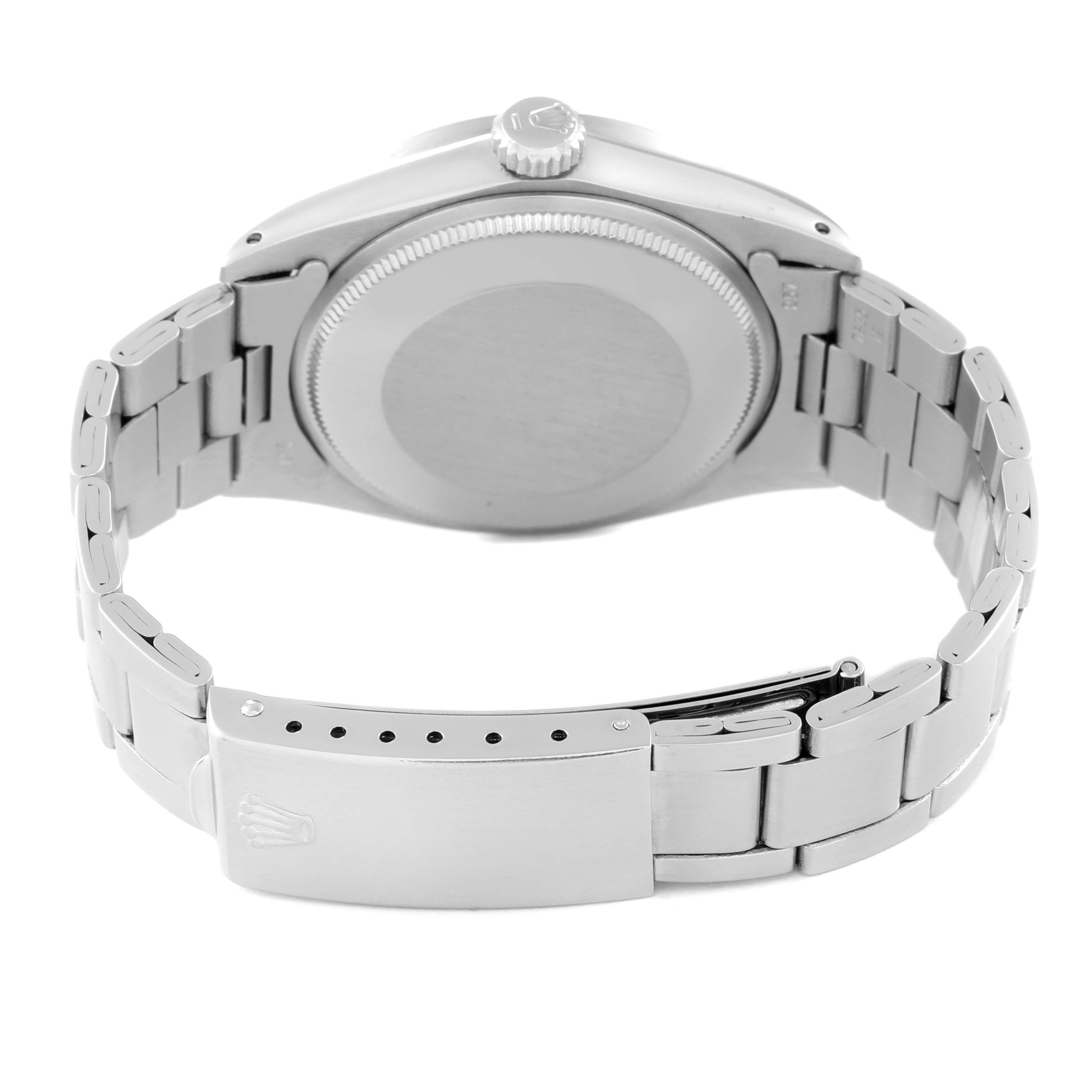 The image shows the back of a Vintage Collection Rolex watch, highlighting the case back, crown, and clasp of the bracelet.