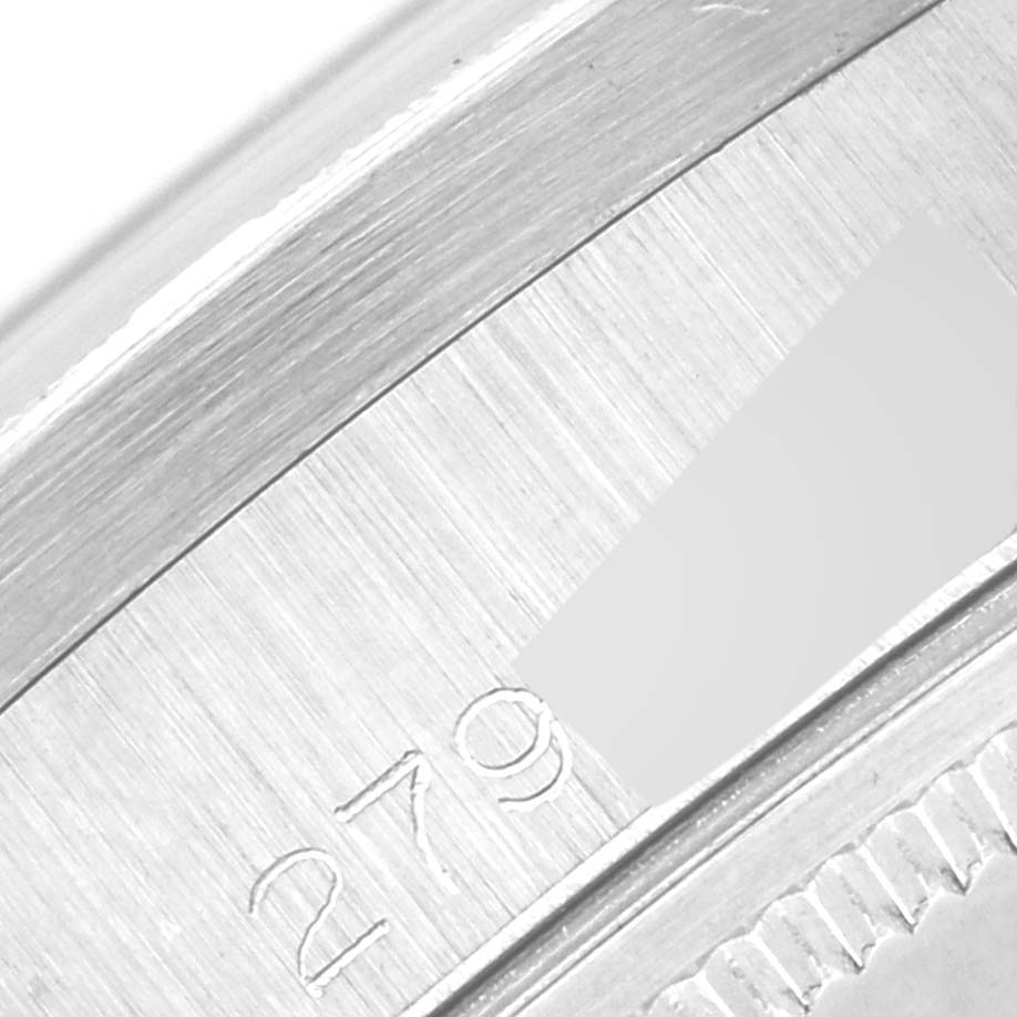 This close-up image shows a portion of the case back of a Vintage Collection model by Rolex, revealing part of the serial number.