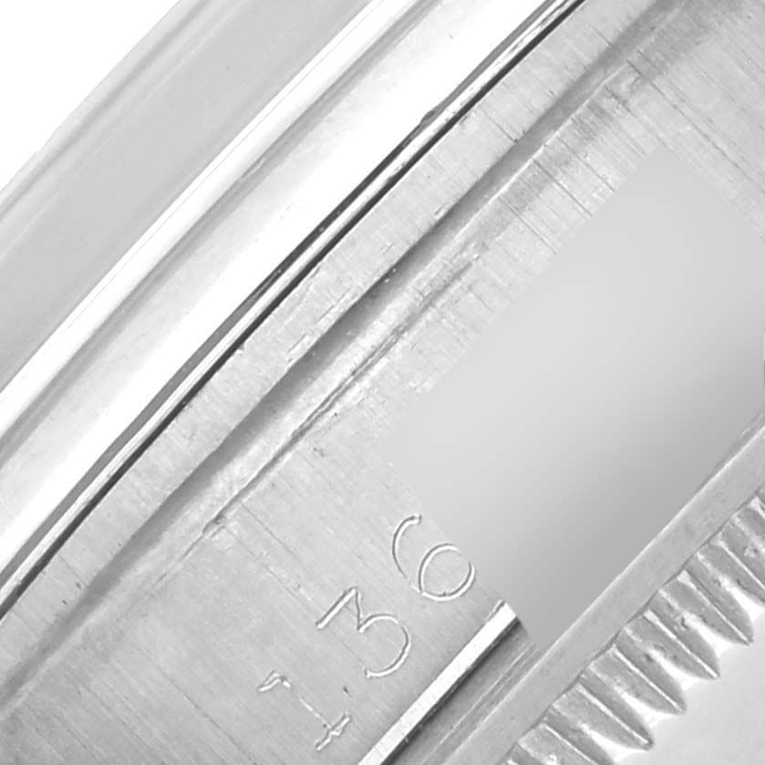 The image shows a close-up of the edge and engraved numbers on the bezel of a Rolex Date 1500 Men's Stainless Steel Silver Dial 1500 Men's Stainless Steel Silver Dial watch.