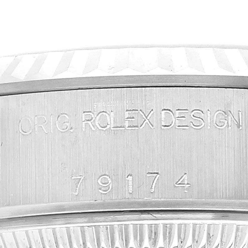 The image shows a close-up of the engraved side of a Rolex Datejust 79174 Women's Stainless Steel Black Dial 79174 Women's Stainless Steel Black Dial watch case, detailing "ORIG. ROLEX DESIGN" and the number "79174."