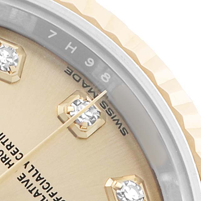 This close-up image shows the dial and bezel of a Rolex Datejust 279173 Women's Stainless Steel Champagne Dial, featuring diamond hour markers and part of the fluted bezel.