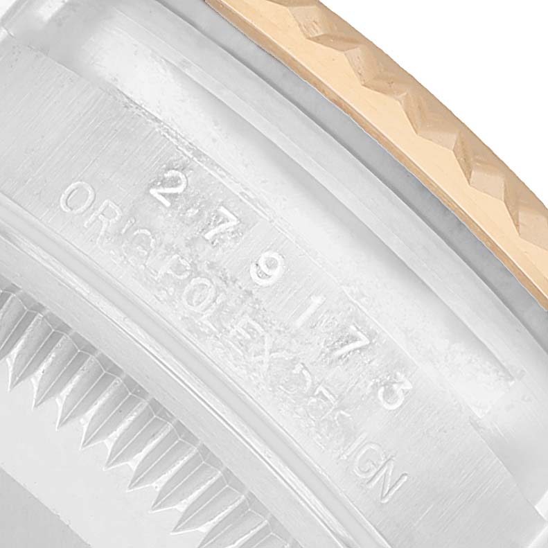 The image shows a close-up of the side of a Rolex Datejust 279173 Women's Steel and Gold (two tone) Champagne Dial, highlighting part of the bezel and case engraving.