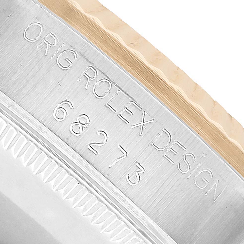 The image shows a close-up of the side of a Rolex Datejust 68273 Women's Stainless Steel Champagne Dial, highlighting the case's engraving and fluted bezel.