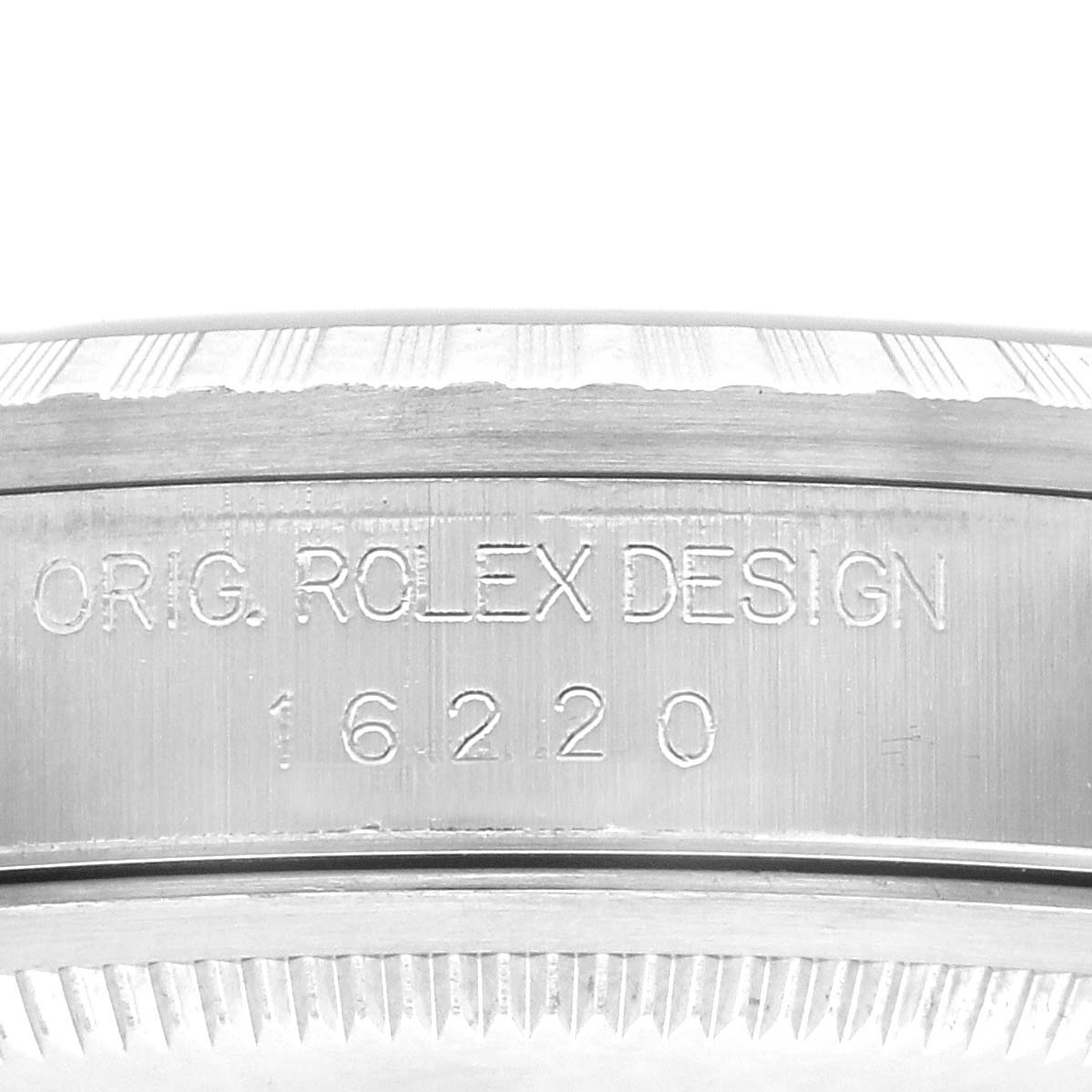 The image shows the side of a Rolex Datejust 16220 Men's Stainless Steel Blue Dial 16220 Men's Stainless Steel Blue Dial watch, highlighting the engraved model number "16220" and "Orig. Rolex Design."