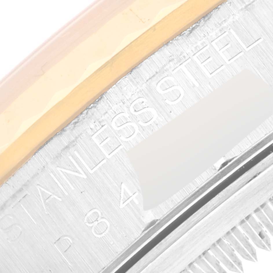 The image shows a close-up of the side of the Rolex Datejust 16233 Men's Steel and Gold (two tone) Black Dial 16233 Men's Steel and Gold (two tone) Black Dial watch, highlighting the "STAINLESS STEEL" engraving on its case.