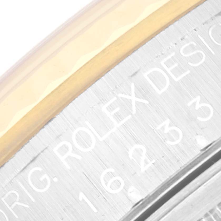 This close-up image shows the bezel and engraved inner ring of a Rolex Datejust 16233 Men's Steel and Gold (two tone) Black Dial 16233 Men's Steel and Gold (two tone) Black Dial watch.