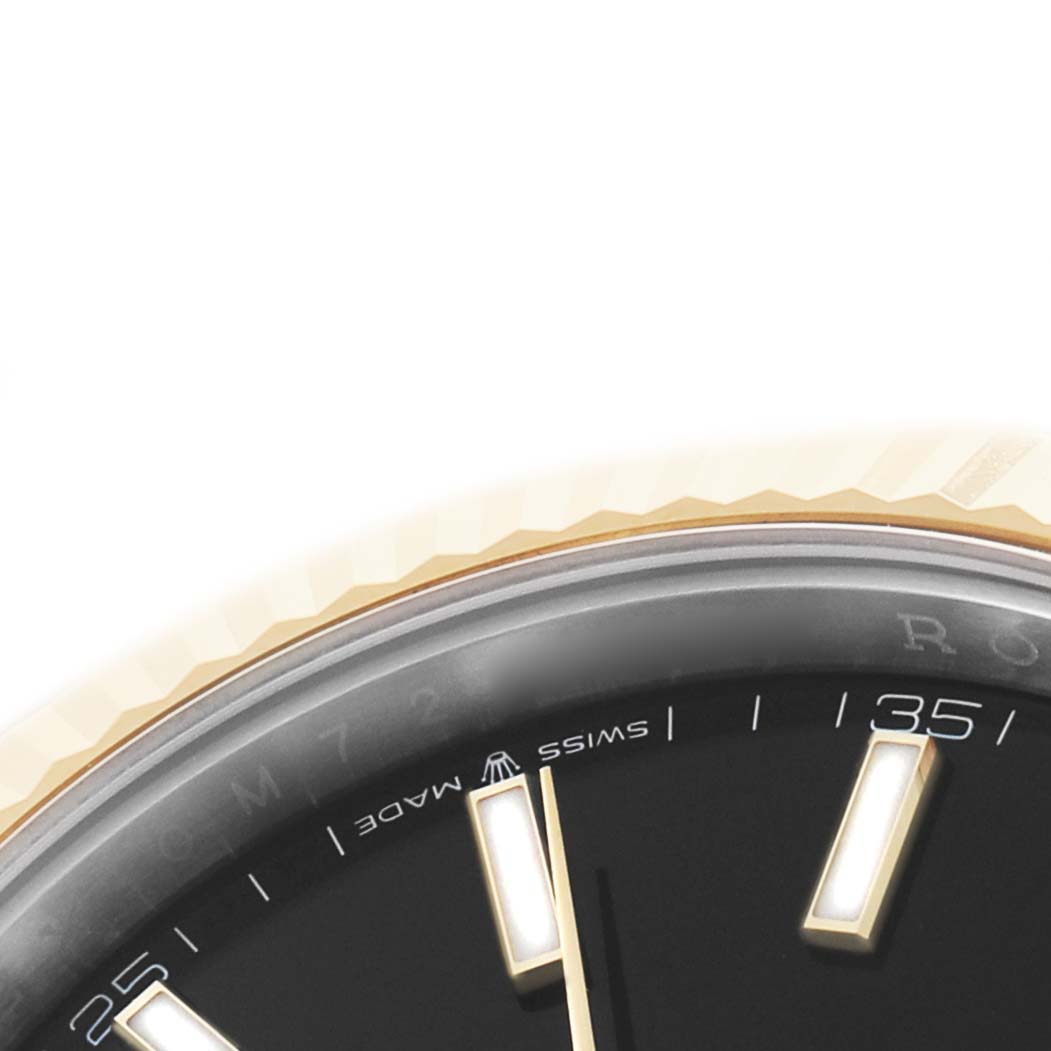 The image shows a close-up of the edge of a Rolex Datejust 41 126333 Men's Steel and Gold (two tone) Black Dial watch, focusing on the bezel and part of the dial.