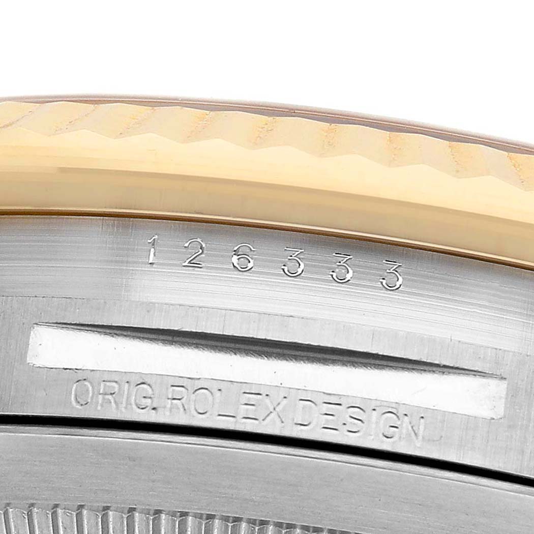 The image shows a close-up of the Rolex Datejust 41 126333 Men's Steel and Gold (two tone) Black Dial model's case with serial numbers and "ORIG. ROLEX DESIGN" engraving.