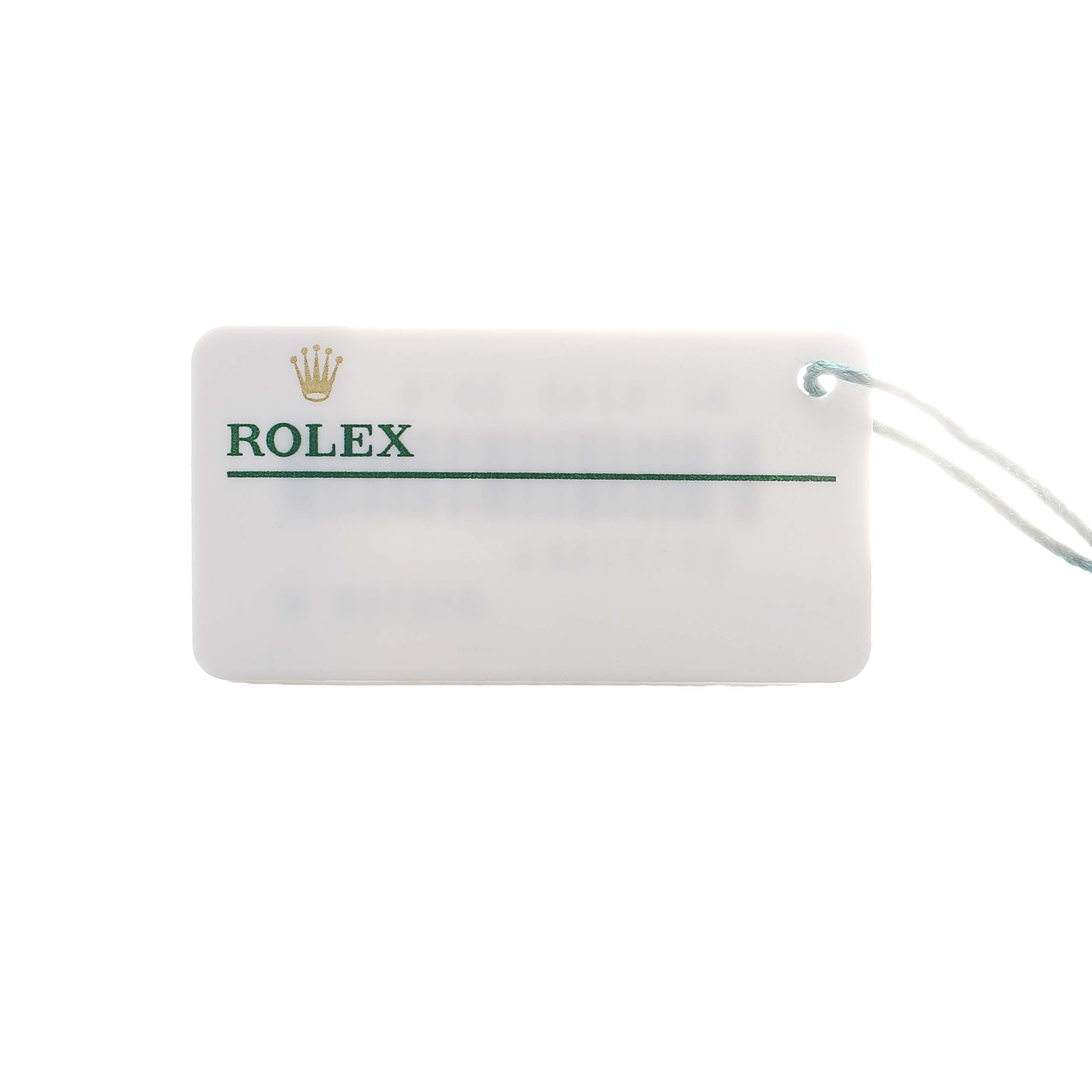 The image shows a Rolex tag, often accompanying a Datejust watch, with the brand name and a string attached.