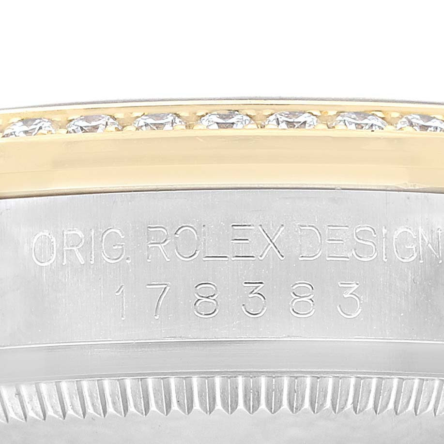 The image shows a close-up of the side of a Rolex Datejust 178383 Women's Steel and Gold (two tone) Champagne Dial watch, featuring the engraved model details and a diamond-set bezel.