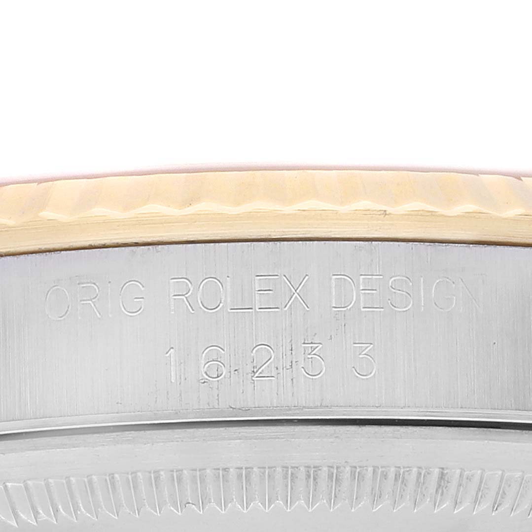 This image shows a close-up of the side of a Rolex Datejust 16233 Men's Steel and Gold (two tone) Champagne Dial 16233 Men's Steel and Gold (two tone) Champagne Dial watch, highlighting its engraved serial number and design inscription.