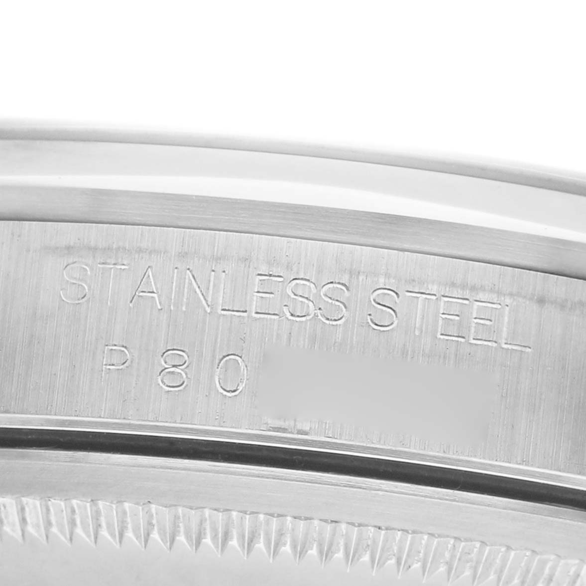 The image shows a close-up of the Rolex Datejust 16200 Men's Stainless Steel Blue Dial's stainless steel casing from the side, highlighting the engraved text.