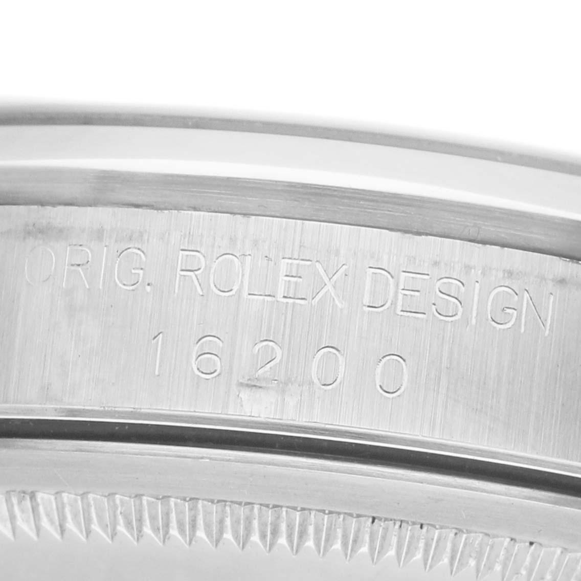 The image shows the engraved side of a Rolex Datejust 16200 Men's Stainless Steel Blue Dial model's watch case, highlighting its design number 16200.