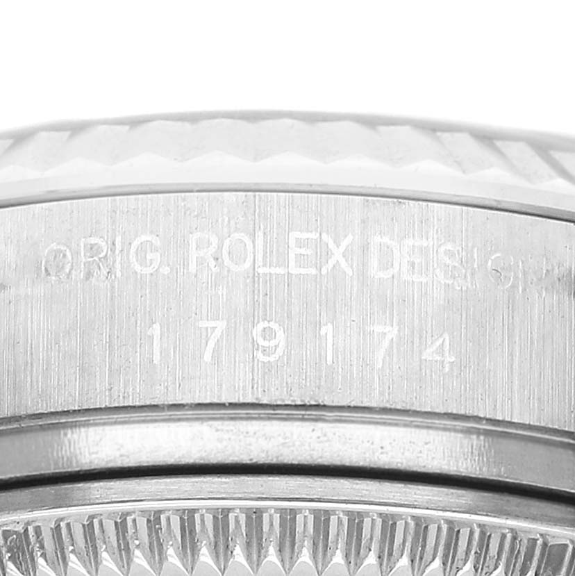 The image shows a close-up of the side of a Rolex Datejust 179174 Women's Stainless Steel Black Dial, highlighting the engraved model number and fluted bezel.