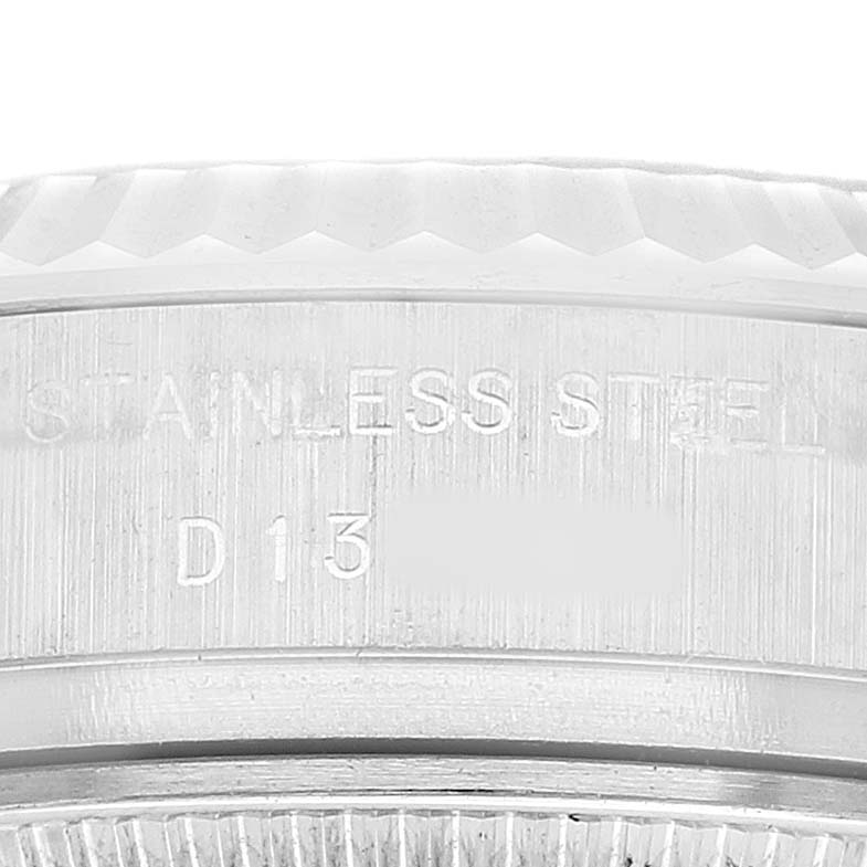 The image shows a close-up of the Rolex Datejust 179174 Women's Stainless Steel Black Dial watch's side, highlighting the stainless steel case and engraved details.