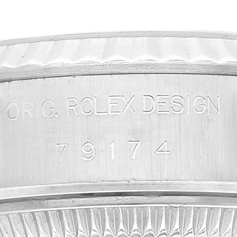 The image shows a close-up view of the case side and serial number of the Rolex Datejust 79174 Women's Stainless Steel Pink Dial 79174 Women's Stainless Steel Pink Dial watch.