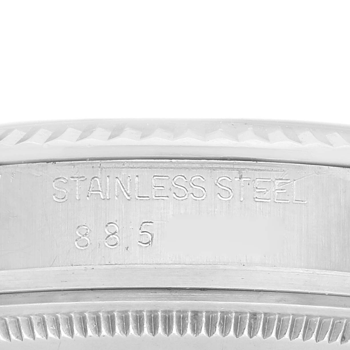 The image shows the side view of the stainless steel bezel and case of a Rolex Vintage Collection 16014 Men
s Stainless Steel Silver Dial 16014 Men
s Stainless Steel Silver Dial watch, inscribed with "STAINLESS STEEL" and a partial number.