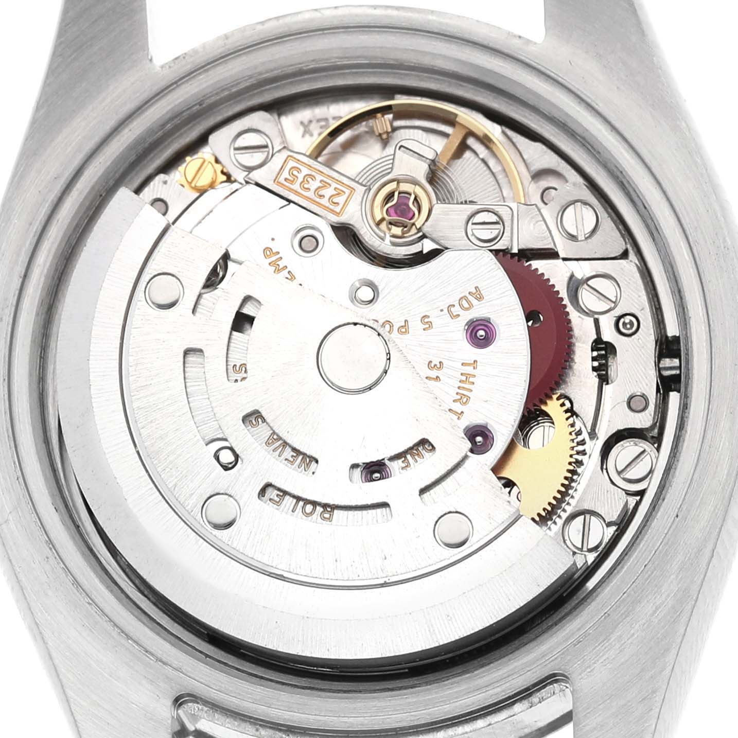 The image shows the movement of a Rolex Datejust 179174 Women's Stainless Steel White Dial watch from a top-down angle, highlighting gears and the rotor.