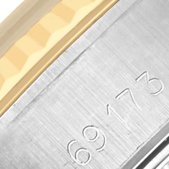 The image shows a close-up of a Rolex Datejust 69173 Women's Steel and Gold (two tone) Black Dial 69173 Women's Steel and Gold (two tone) Black Dial model's bracelet and serial number.