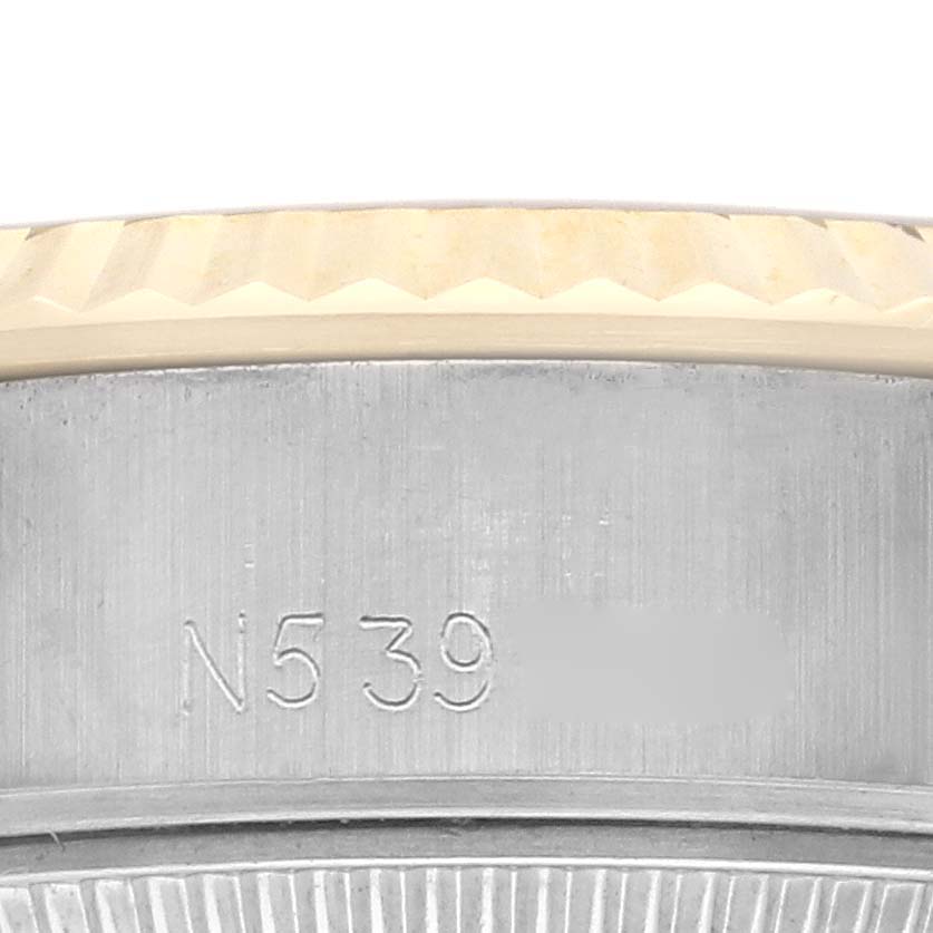 The image shows a close-up of the side of a Rolex Datejust 69173 Women's Steel and Gold (two tone) Champagne Dial 69173 Women's Steel and Gold (two tone) Champagne Dial, displaying the case and part of the bezel with engravings.