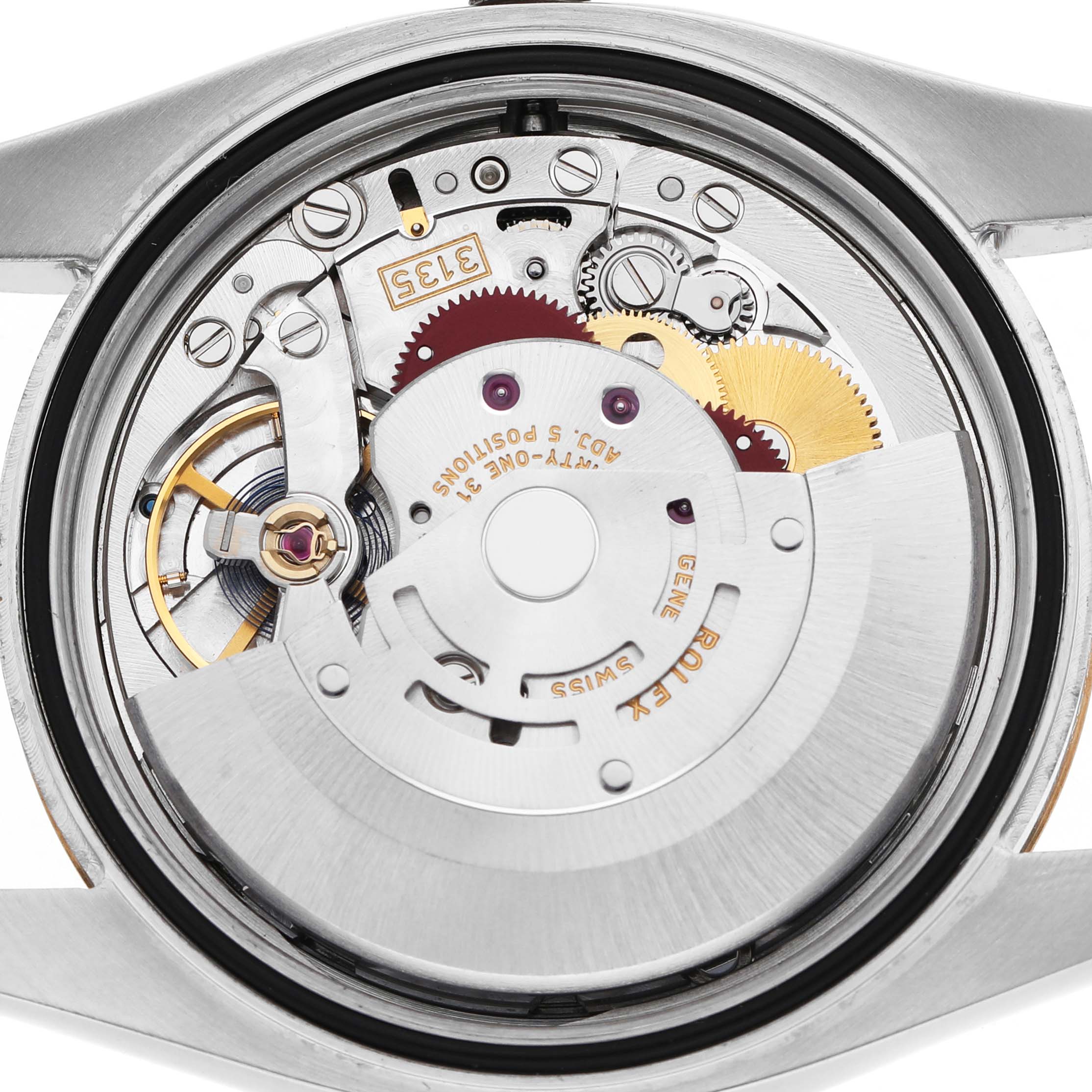 The image shows the movement of a Rolex Datejust 116233 Men's Stainless Steel Silver Dial watch from the back, highlighting gears and the rotor.
