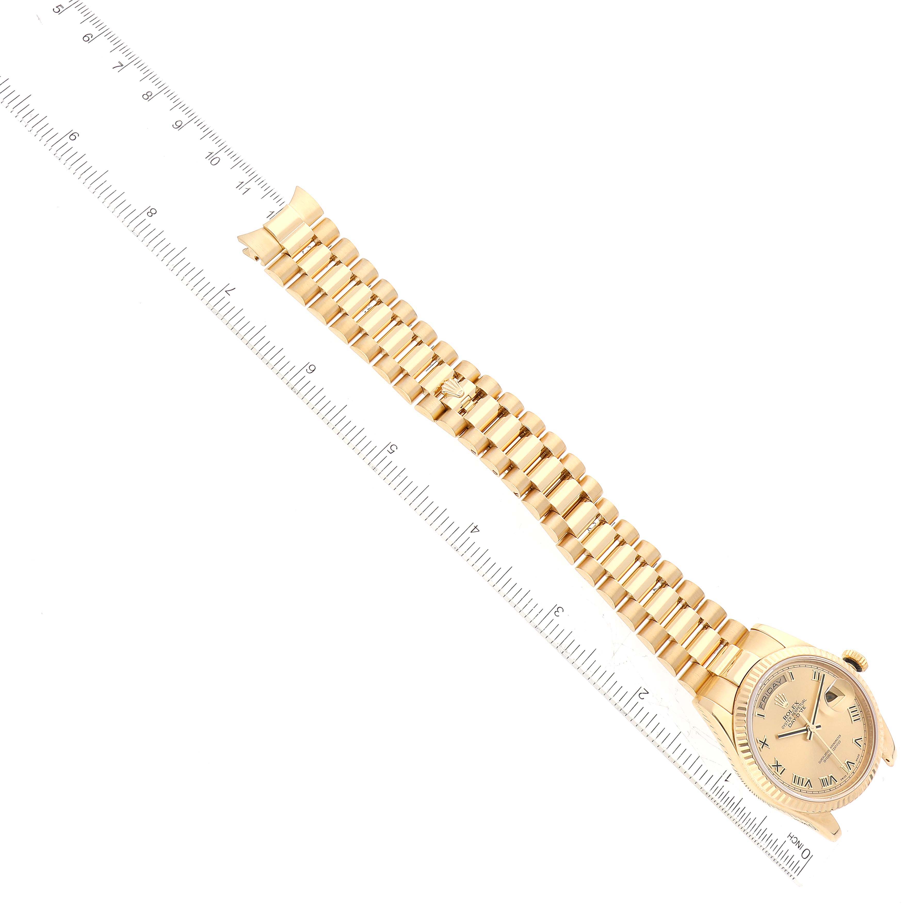 This image shows a Rolex President 118238 Men
s Yellow Gold Champagne Dial 118238 Men
s Yellow Gold Champagne Dial model watch at a top-down angle, including the face, band, and part of a ruler for scale.