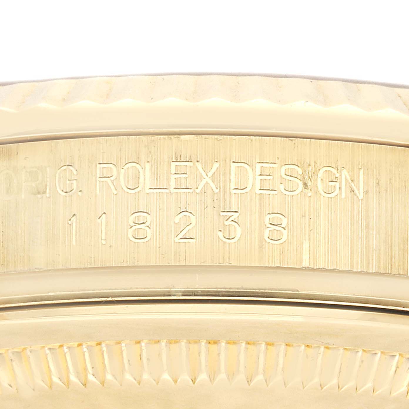 This close-up image shows the engraved serial number and the edge of the bezel of a Rolex President 118238 Men
s Yellow Gold Champagne Dial 118238 Men
s Yellow Gold Champagne Dial model watch.